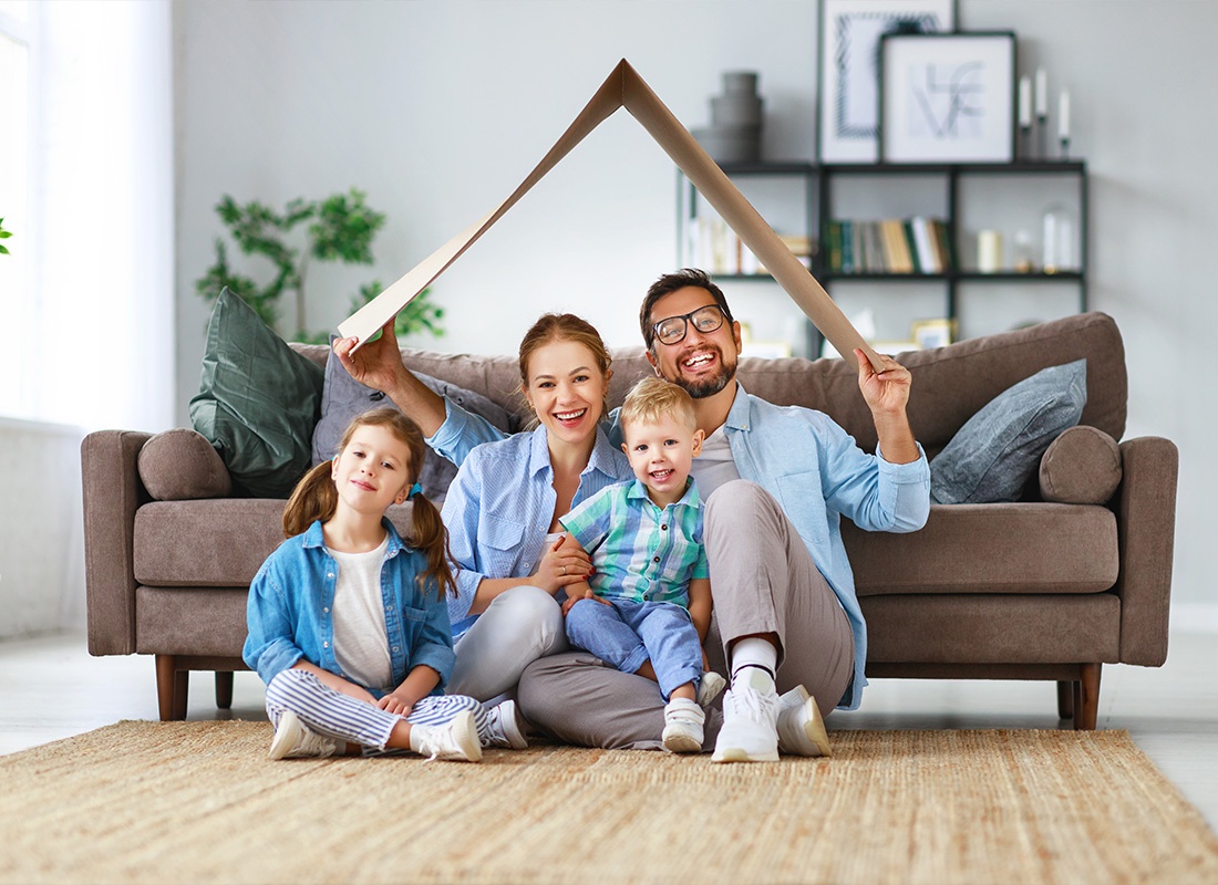 Personal Insurance - A Young Family Taking a Portrait Photo While Sitting on Their Living Room Floor at Home